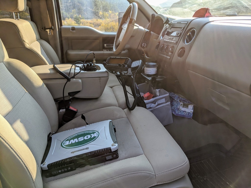 Truck passenger seat with radios and a laptop